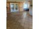 Empty living room featuring tile floors and double doors leading to the outside at 3238 Coldwell Dr, Holiday, FL 34691