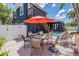 Backyard view of a patio table with chairs, red umbrella, and swimming pool at 3450 Ferrell St, New Port Richey, FL 34655