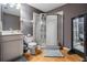 Well-lit bathroom with a glass shower, toilet, and vanity with neutral-toned walls and laminate flooring at 3450 Ferrell St, New Port Richey, FL 34655