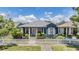 Charming blue home features a picket fence and inviting front porch at 3450 Ferrell St, New Port Richey, FL 34655
