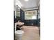 Retro bathroom features black tile walls, pink tub and sink, and updated flooring at 34577 Orchid Pkwy, Dade City, FL 33523