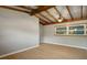 The bedroom features light grey walls, updated flooring, and a window overlooking the yard at 34577 Orchid Pkwy, Dade City, FL 33523