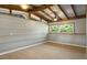 The bonus room has wood beam ceilings, plank walls, updated flooring, and large windows at 34577 Orchid Pkwy, Dade City, FL 33523