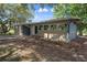 Side view of single story home featuring brick accents and a large, covered parking area at 34577 Orchid Pkwy, Dade City, FL 33523