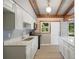 Bright kitchen featuring stainless steel appliances, stone countertops, white cabinets, and modern flooring at 34577 Orchid Pkwy, Dade City, FL 33523