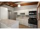 Well-lit kitchen featuring white cabinets, granite countertops, and stainless steel appliances at 34577 Orchid Pkwy, Dade City, FL 33523