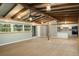 Open-concept living area with modern floors flowing into the kitchen with white cabinets and stainless steel appliances at 34577 Orchid Pkwy, Dade City, FL 33523