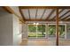 Open-concept living space with wood floors and large windows overlooking the landscaped backyard at 34577 Orchid Pkwy, Dade City, FL 33523
