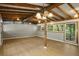 Sunroom featuring wood-beam ceiling, recessed lighting, and abundant natural light streaming through many windows at 34577 Orchid Pkwy, Dade City, FL 33523