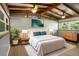Inviting bedroom with natural light, wood floors, exposed beams, and neutral décor at 34577 Orchid Pkwy, Dade City, FL 33523
