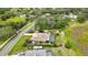 Beautiful aerial view of the property with a screened-in pool and lush landscaping at 364 Waterfall Dr, Spring Hill, FL 34608