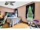 Bright bedroom with hardwood floors, a large window, and eclectic decor at 364 Waterfall Dr, Spring Hill, FL 34608