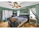 Comfortable bedroom with a ceiling fan and stylish curtains at 364 Waterfall Dr, Spring Hill, FL 34608