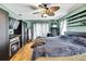 Cozy bedroom features a ceiling fan and wood laminate flooring at 364 Waterfall Dr, Spring Hill, FL 34608