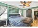 Bedroom features a ceiling fan, wood laminate flooring, and closet at 364 Waterfall Dr, Spring Hill, FL 34608