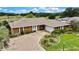 Home exterior with an arched entry, well-maintained landscaping, and a spacious driveway with garage access at 364 Waterfall Dr, Spring Hill, FL 34608