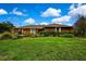 Expansive single-story home features a lush green lawn and mature landscaping, offering great curb appeal at 364 Waterfall Dr, Spring Hill, FL 34608