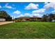 Beautiful single-story home featuring a large front yard with lush green grass and mature landscaping at 364 Waterfall Dr, Spring Hill, FL 34608