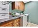 Functional laundry room with washer, dryer, cabinets, and countertop at 364 Waterfall Dr, Spring Hill, FL 34608