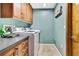 Convenient laundry room with front loading washer and dryer and wood cabinets at 364 Waterfall Dr, Spring Hill, FL 34608