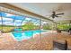 Relaxing screened-in pool with brick paving and clear blue water at 364 Waterfall Dr, Spring Hill, FL 34608