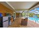 Backyard featuring a screened-in pool, brick patio, and outdoor seating area at 364 Waterfall Dr, Spring Hill, FL 34608