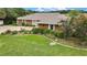 Aerial view of home with mature flowering trees and manicured shrubbery and a backdrop of natural scenery at 364 Waterfall Dr, Spring Hill, FL 34608