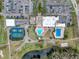 An aerial view of the community clubhouse with pools, parking, and tennis courts at 3712 Trophy Blvd # 3712, New Port Richey, FL 34655
