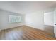 Bedroom featuring wood-look floors, a window, and an open door to another room at 3712 Trophy Blvd # 3712, New Port Richey, FL 34655