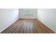 Bright bedroom featuring wood-look floors and a window at 3712 Trophy Blvd # 3712, New Port Richey, FL 34655