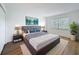 Bedroom with a made bed, two side tables, a plant, and a window at 3712 Trophy Blvd # 3712, New Port Richey, FL 34655