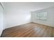 Bright bedroom featuring wood-look floors, a window, and a closet at 3712 Trophy Blvd # 3712, New Port Richey, FL 34655