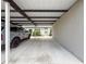 Attached carport providing covered parking, with condo entrance and landscaping at 3712 Trophy Blvd # 3712, New Port Richey, FL 34655