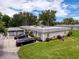 A view of a condo with a carport and well-maintained landscaping and lawn at 3712 Trophy Blvd # 3712, New Port Richey, FL 34655