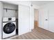 Laundry closet features full size washing machine and storage area at 3712 Trophy Blvd # 3712, New Port Richey, FL 34655