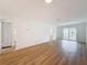 Living room features wood-look floors, neutral walls and sliding glass doors at 3712 Trophy Blvd # 3712, New Port Richey, FL 34655