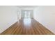 Open-concept living room with wood-look floors and sliding glass door at 3712 Trophy Blvd # 3712, New Port Richey, FL 34655