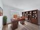 Comfortable home office setup with wooden desk, chair, shelving, and natural light at 3712 Trophy Blvd # 3712, New Port Richey, FL 34655