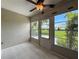 Enclosed porch featuring tile floors, multiple windows, and a ceiling fan at 3712 Trophy Blvd # 3712, New Port Richey, FL 34655