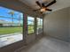 Enclosed porch featuring tile floors, multiple windows, and a ceiling fan at 3712 Trophy Blvd # 3712, New Port Richey, FL 34655