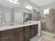 Beautiful bathroom with double vanity, granite countertop, and walk-in shower at 3885 Villamore Ln, Odessa, FL 33556