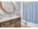 Elegant bathroom with granite counter, and nautical themed wall paper creating a spa-like retreat at 3885 Villamore Ln, Odessa, FL 33556