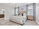 Relaxing bedroom featuring large windows, bedside tables, and stylish decor at 3885 Villamore Ln, Odessa, FL 33556