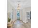 Inviting foyer with decorative lighting, light grey walls, and a modern front door with a wreath at 3885 Villamore Ln, Odessa, FL 33556