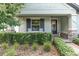 Attractive home exterior featuring a well-manicured lawn, front porch with rocking chairs, and beautiful landscaping at 3885 Villamore Ln, Odessa, FL 33556
