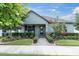 Charming home exterior with a manicured lawn, inviting front porch, and blossoming landscaping at 3885 Villamore Ln, Odessa, FL 33556
