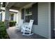 Charming front porch with classic rocking chairs and a brick paver walkway exudes a welcoming ambiance at 3885 Villamore Ln, Odessa, FL 33556