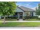 Charming single-story home with beautiful landscaping, a welcoming front porch, and a well-maintained lawn at 3885 Villamore Ln, Odessa, FL 33556