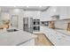 Bright kitchen with stainless steel appliances, white cabinets and a large island with marble countertops at 3885 Villamore Ln, Odessa, FL 33556