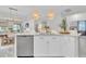 Open-concept kitchen featuring a central island with bar seating, modern appliances, and abundant natural light at 3885 Villamore Ln, Odessa, FL 33556